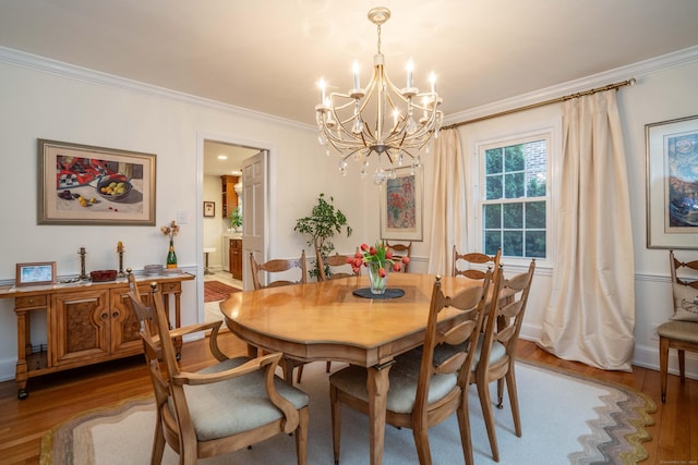 341 Quaker Ln N, West Hartford, CT 06119 - dining area featuring crown molding, a chandelier, light wood-type flooring, and baseboards