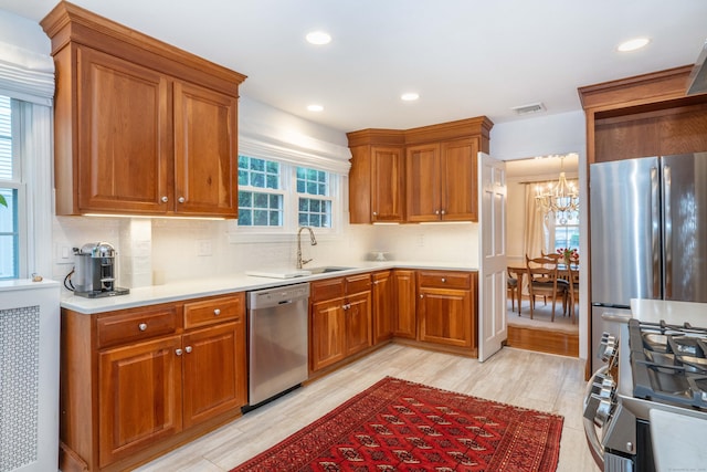 341 Quaker Ln N, West Hartford, CT 06119 - kitchen with appliances with stainless steel finishes, backsplash, a sink, a chandelier, and recessed lighting