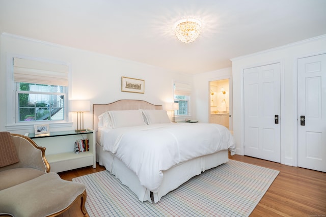 341 Quaker Ln N, West Hartford, CT 06119 - bedroom featuring ornamental molding, wood finished floors, multiple windows, and ensuite bath