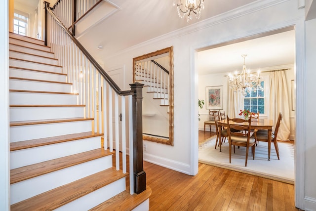 341 Quaker Ln N, West Hartford, CT 06119 - stairs featuring a chandelier, wood-type flooring, crown molding, baseboards, and healthy amount of natural light
