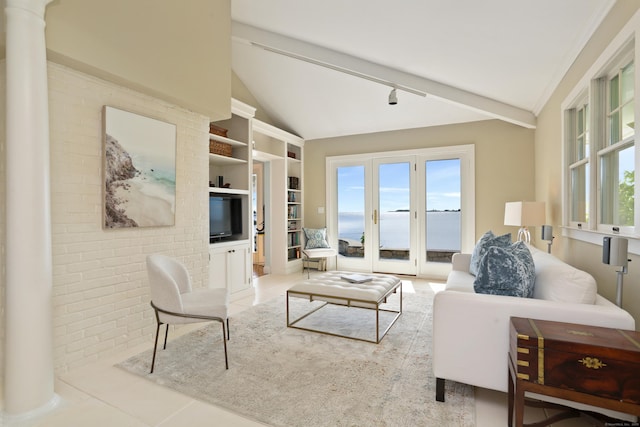 tiled living area with lofted ceiling and built in shelves