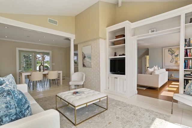 living area featuring tile patterned floors, ornamental molding, and high vaulted ceiling