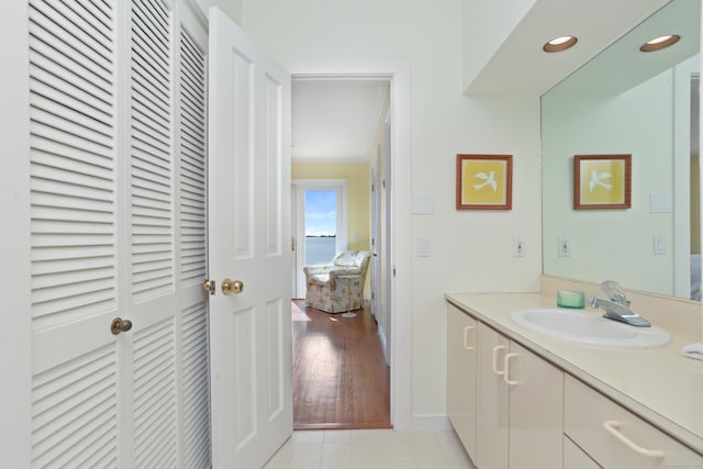 bathroom with vanity, baseboards, and tile patterned floors