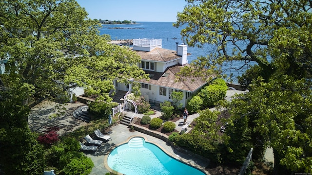view of subject property with a large body of water and a pool