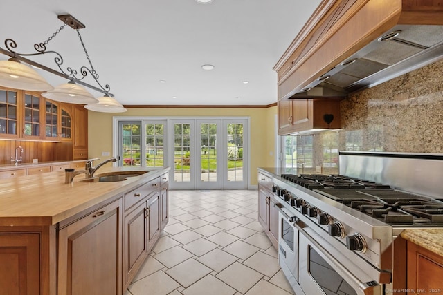 24 Lawrence Hill Rd, Stamford, CT 06903 - kitchen with range with two ovens, premium range hood, a sink, ornamental molding, and brown cabinetry