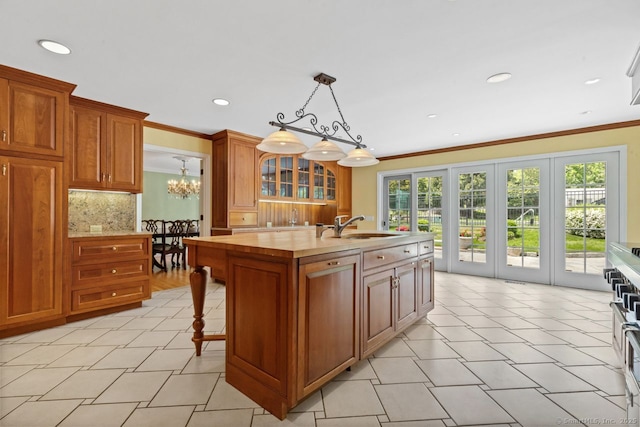 24 Lawrence Hill Rd, Stamford, CT 06903 - kitchen with a sink, tasteful backsplash, a chandelier, recessed lighting, and glass insert cabinets