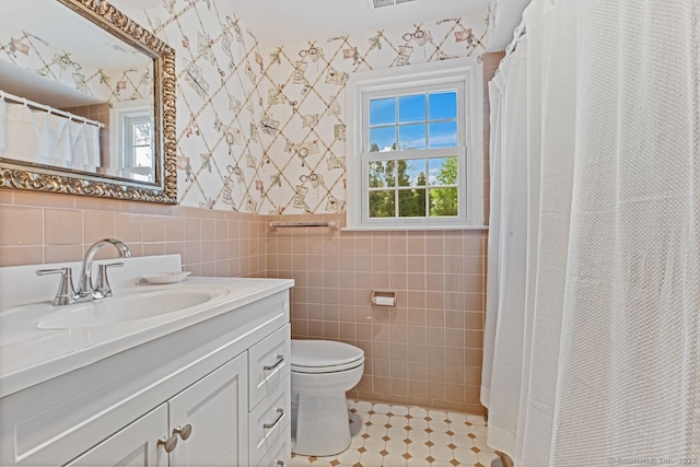 24 Lawrence Hill Rd, Stamford, CT 06903 - bathroom featuring wallpapered walls, a wainscoted wall, vanity, toilet, and tile walls