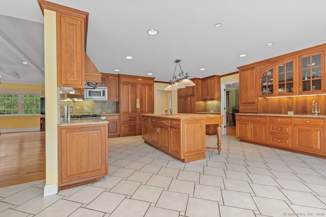 24 Lawrence Hill Rd, Stamford, CT 06903 - kitchen with stainless steel microwave, light countertops, tasteful backsplash, a kitchen island with sink, and recessed lighting