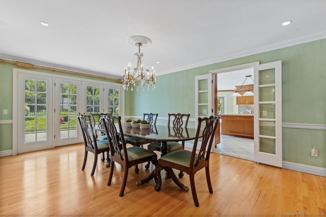 24 Lawrence Hill Rd, Stamford, CT 06903 - dining area with french doors, a chandelier, light wood finished floors, crown molding, and baseboards