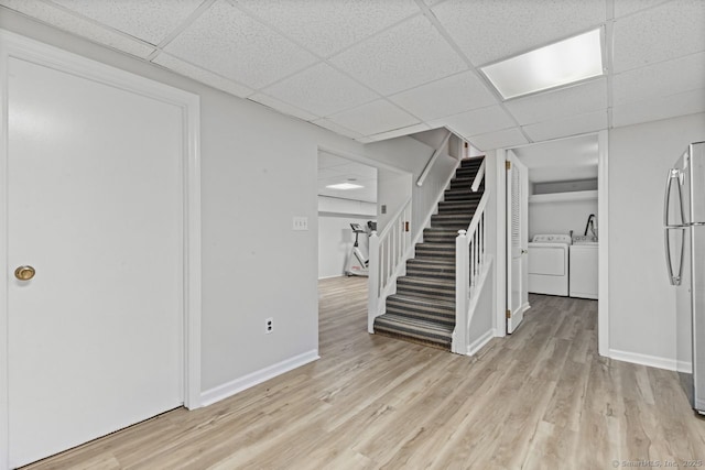 24 Lawrence Hill Rd, Stamford, CT 06903 - foyer entrance featuring washing machine and clothes dryer, stairs, light wood-style flooring, a paneled ceiling, and baseboards
