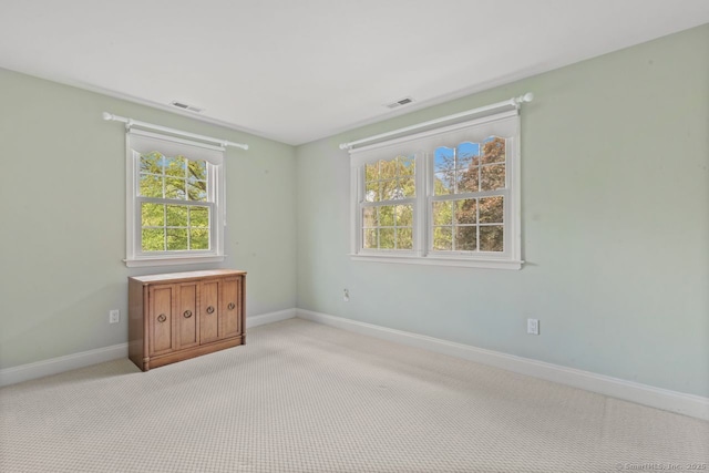 24 Lawrence Hill Rd, Stamford, CT 06903 - empty room featuring healthy amount of natural light, baseboards, and light colored carpet