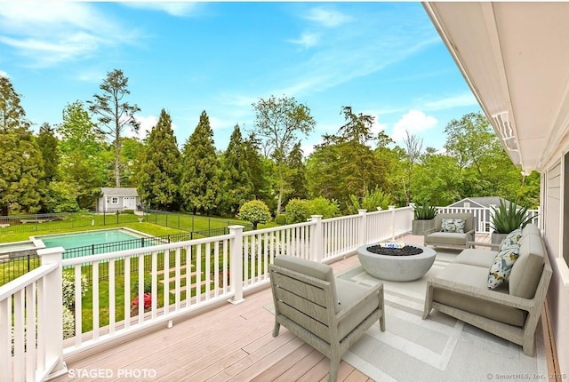 24 Lawrence Hill Rd, Stamford, CT 06903 - deck featuring an outdoor living space with a fire pit, view of scattered trees, and an outbuilding