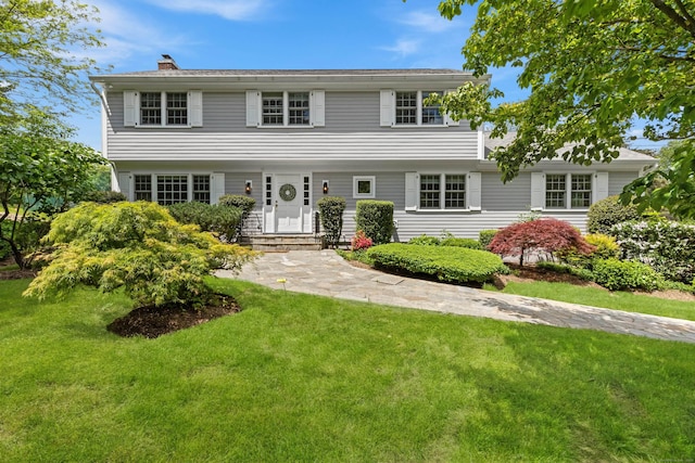 24 Lawrence Hill Rd, Stamford, CT 06903 - colonial-style house featuring a front yard and a chimney