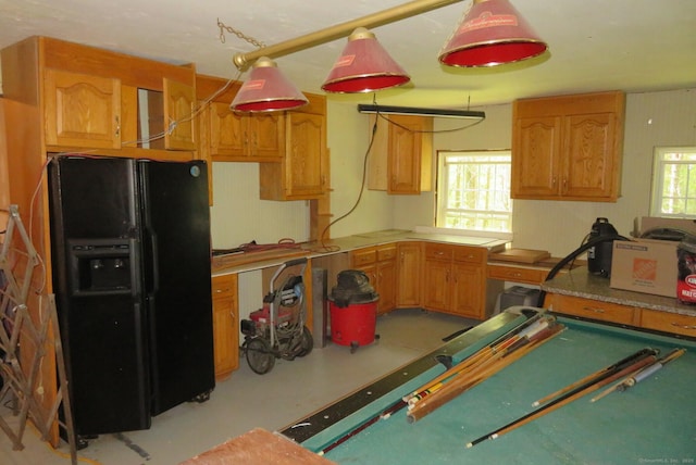 kitchen featuring black fridge and light countertops
