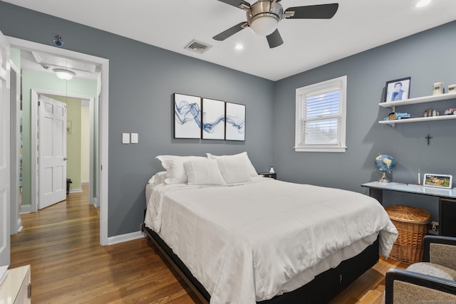 bedroom featuring wood finished floors, recessed lighting, baseboards, ceiling fan, and attic access