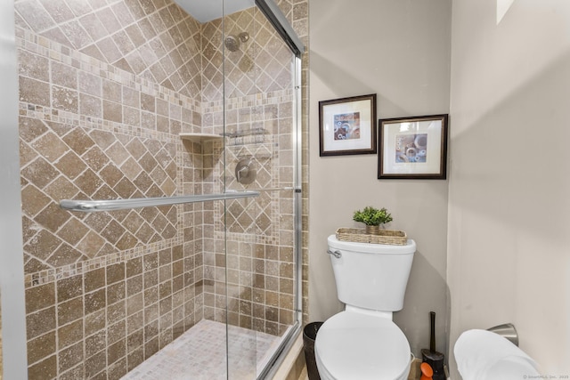 bathroom featuring a shower stall and toilet