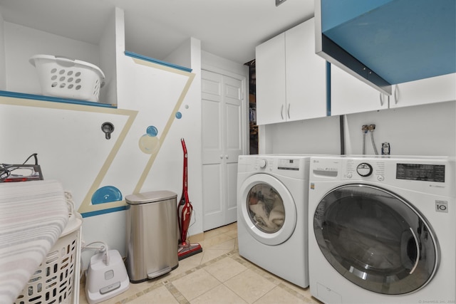 washroom with cabinet space, washing machine and dryer, light tile patterned flooring, and inlaid floor details