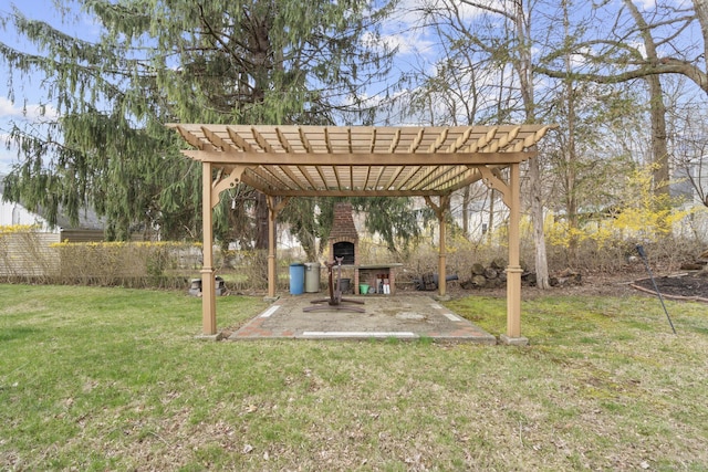view of yard with an outdoor fireplace, a pergola, and a patio area