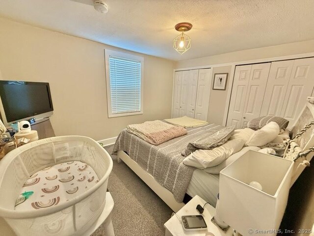 661 E Main St, Stratford, CT 06614 - bedroom with multiple closets, baseboards, and carpet flooring