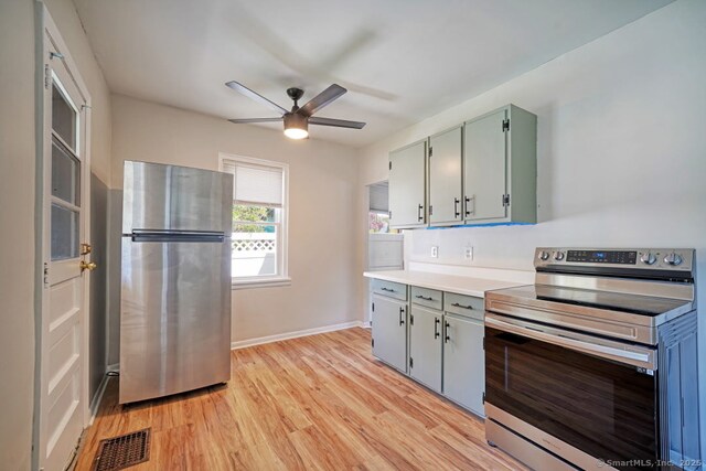 661 E Main St, Stratford, CT 06614 - kitchen featuring appliances with stainless steel finishes, a ceiling fan, light wood-style floors, light countertops, and baseboards