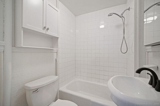 661 E Main St, Stratford, CT 06614 - full bath featuring a sink, tile walls, toilet, and washtub / shower combination