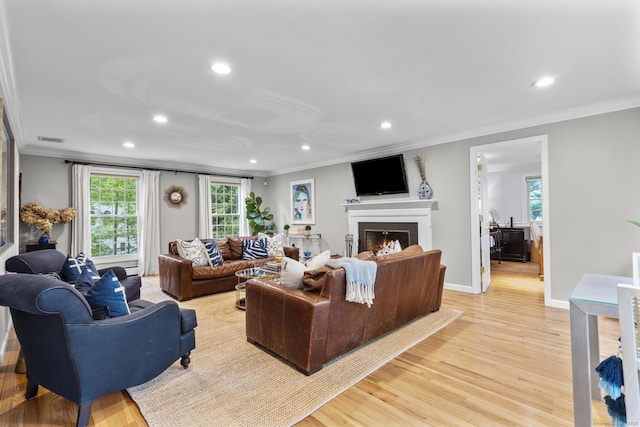 94 Glen Dr, New Canaan, CT 06840 - living area with recessed lighting, ornamental molding, light wood-style flooring, a lit fireplace, and plenty of natural light