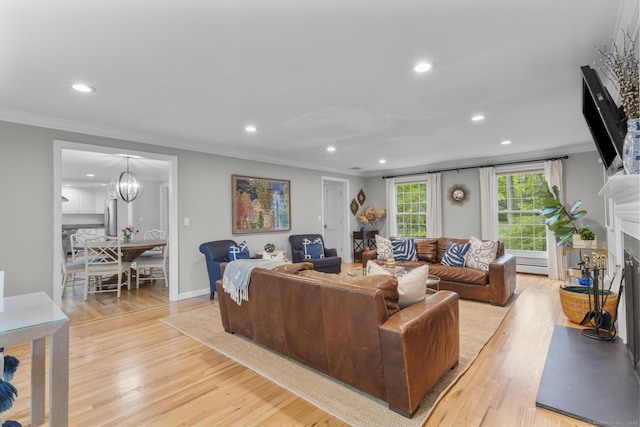94 Glen Dr, New Canaan, CT 06840 - living room featuring crown molding, recessed lighting, light wood-style flooring, a fireplace, and a chandelier