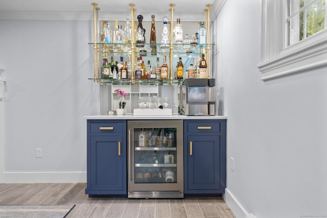 94 Glen Dr, New Canaan, CT 06840 - indoor dry bar with wine cooler, crown molding, light wood-type flooring, and baseboards