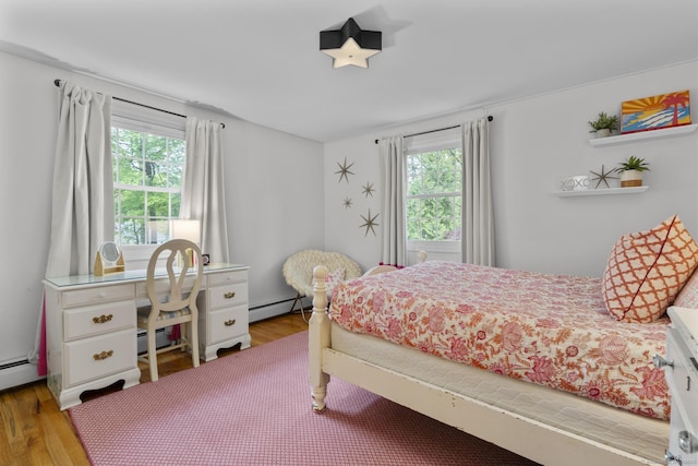 94 Glen Dr, New Canaan, CT 06840 - bedroom featuring multiple windows, wood finished floors, baseboard heating, and a baseboard radiator
