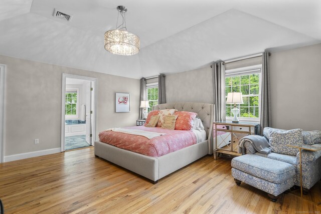94 Glen Dr, New Canaan, CT 06840 - bedroom featuring light wood finished floors, a chandelier, lofted ceiling, ensuite bath, and baseboards