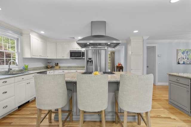 94 Glen Dr, New Canaan, CT 06840 - kitchen with island range hood, stainless steel appliances, a sink, ornamental molding, and a center island
