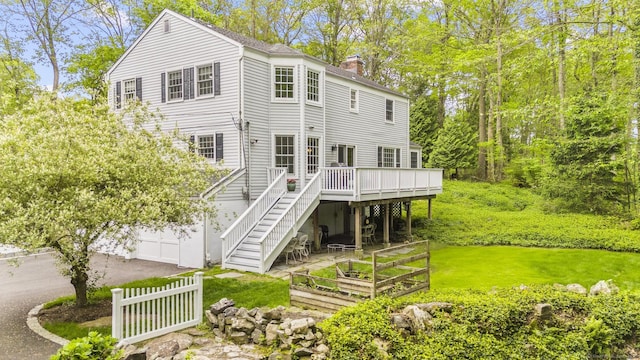 94 Glen Dr, New Canaan, CT 06840 - back of house featuring a wooden deck, a chimney, stairway, a vegetable garden, and a yard