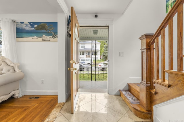entryway with stairway and baseboards