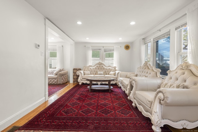 living room featuring dark wood finished floors, recessed lighting, and baseboards