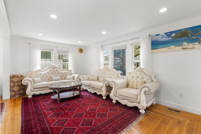 living room featuring recessed lighting, baseboards, and wood finished floors