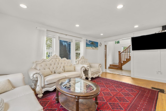 living room featuring recessed lighting, stairway, and wood finished floors
