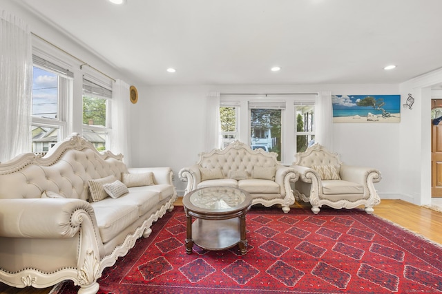 living room featuring plenty of natural light, recessed lighting, baseboards, and wood finished floors