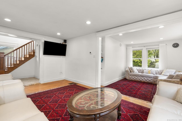 living area with stairway, wood finished floors, recessed lighting, and baseboards