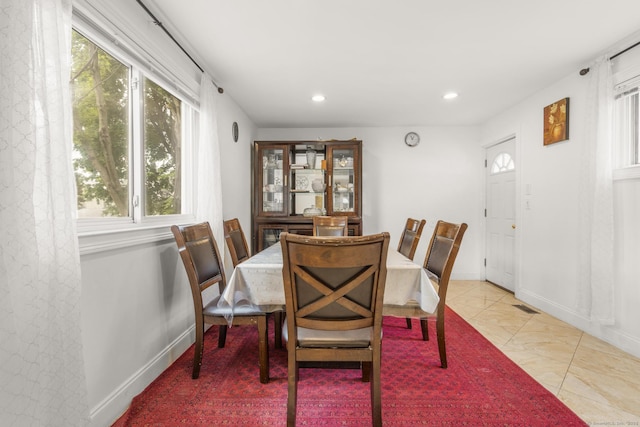 dining space featuring healthy amount of natural light, recessed lighting, and baseboards