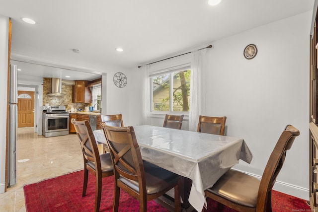 dining space featuring recessed lighting and baseboards
