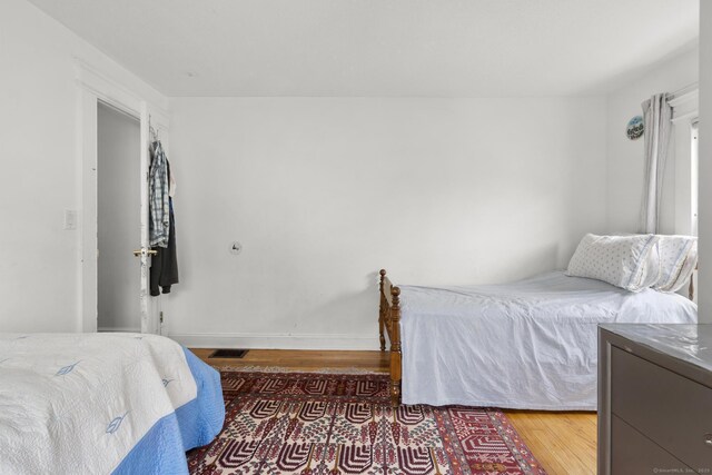 bedroom featuring wood finished floors and baseboards