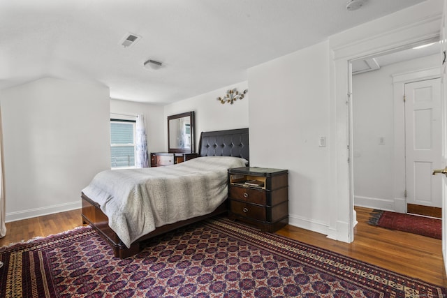 bedroom featuring wood finished floors and baseboards