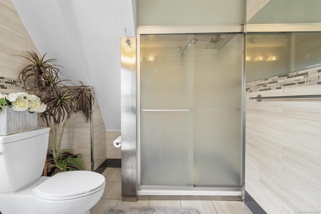 bathroom featuring a shower stall and toilet