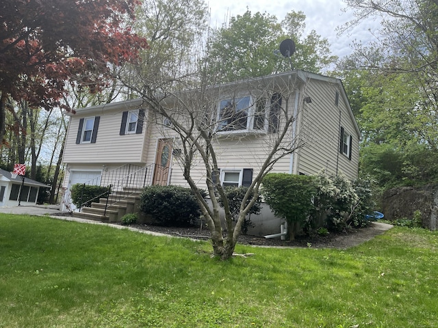 view of front of home with a garage and a front yard