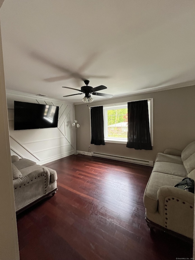 bedroom with a baseboard radiator, baseboards, wood finished floors, and a ceiling fan