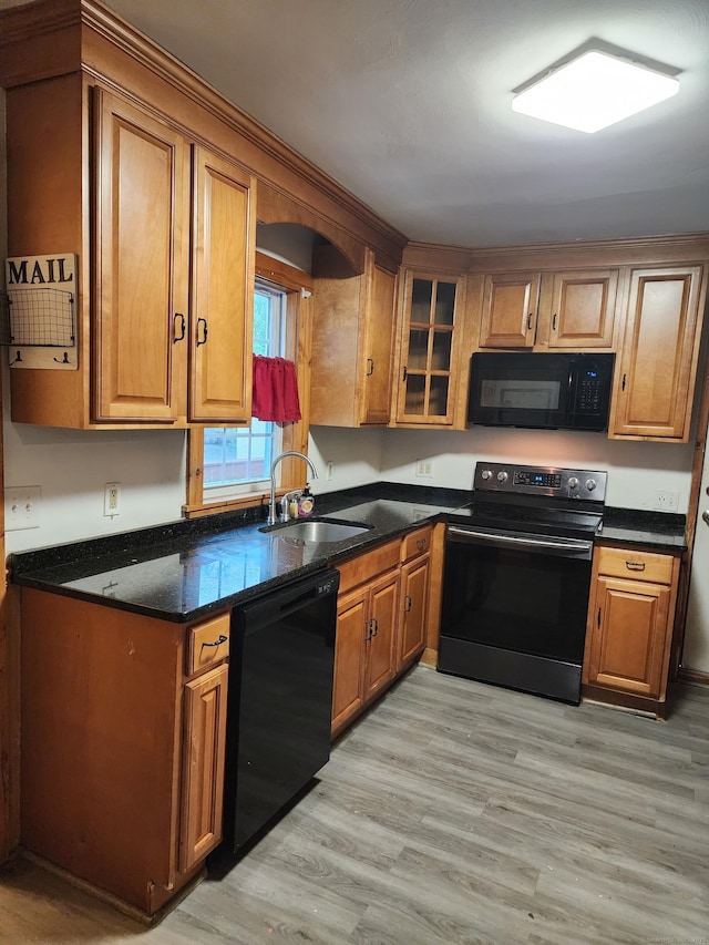 348 Harwinton Ave, Torrington, CT 06790 - kitchen featuring black appliances, a sink, brown cabinetry, and light wood-type flooring