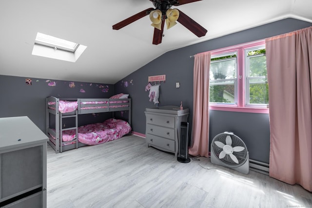 348 Harwinton Ave, Torrington, CT 06790 - bedroom featuring vaulted ceiling, wood finished floors, a skylight, ceiling fan, and baseboard heating