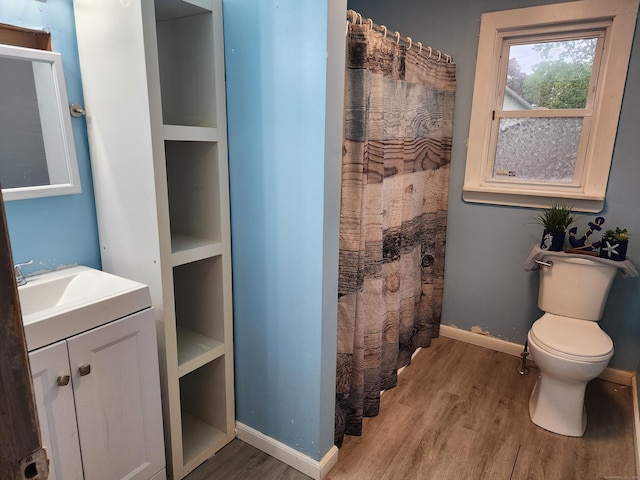348 Harwinton Ave, Torrington, CT 06790 - full bath with wood finished floors, toilet, vanity, and baseboards