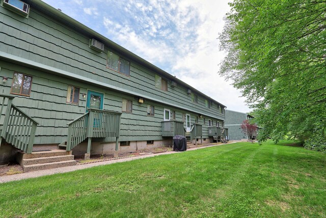 1400 Meriden Rd Apt 1-2, Waterbury, CT 06705 - back of house with a yard and a wall unit AC