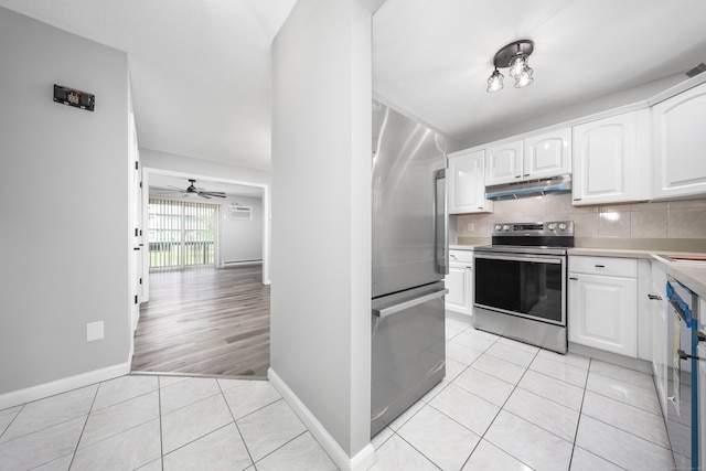 1400 Meriden Rd Apt 1-2, Waterbury, CT 06705 - kitchen featuring stainless steel appliances, under cabinet range hood, light tile patterned floors, white cabinetry, and light countertops